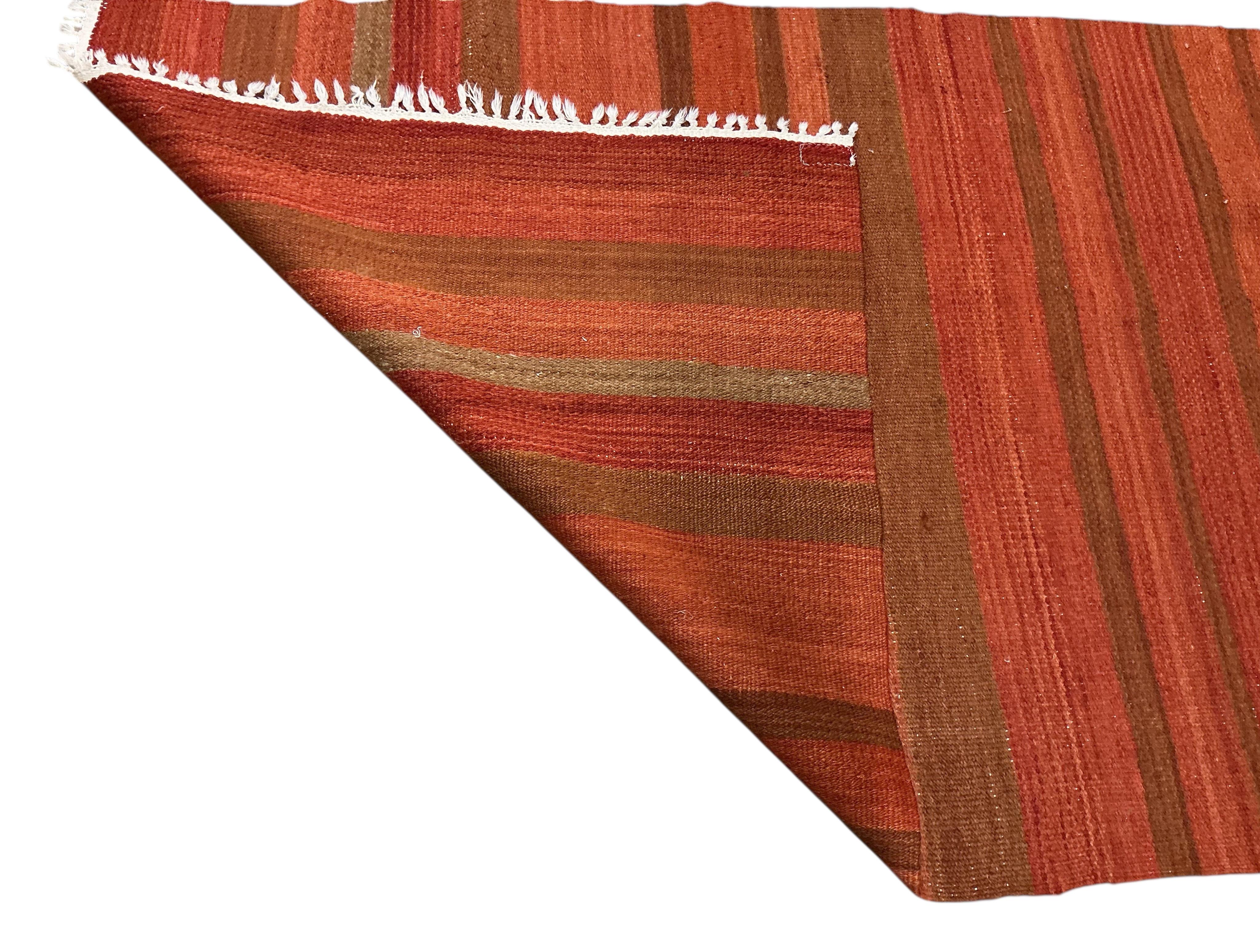 A North West Persian fawn ground rug, 196 x 126cm together with a flatweave rug